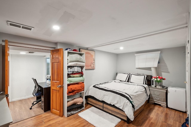 bedroom featuring recessed lighting, visible vents, and wood finished floors