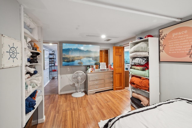 bedroom featuring visible vents, baseboards, and light wood-style floors