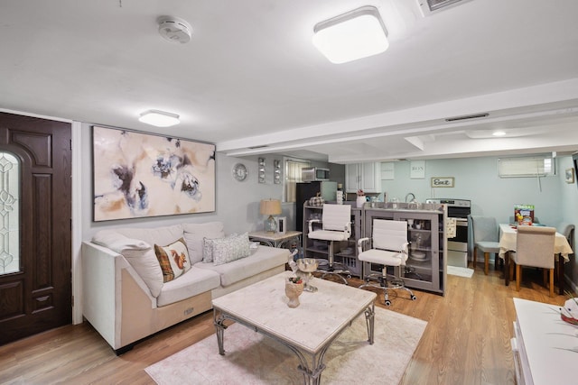 living area with visible vents and light wood-style flooring