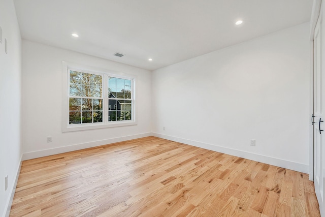 unfurnished room with recessed lighting, baseboards, light wood-type flooring, and visible vents