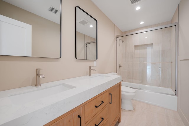 full bathroom with a sink, double vanity, toilet, recessed lighting, and combined bath / shower with glass door