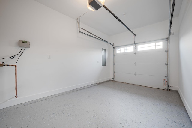 garage featuring baseboards, a garage door opener, and electric panel