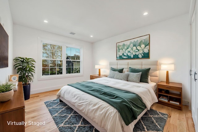 bedroom featuring baseboards, recessed lighting, wood finished floors, and visible vents