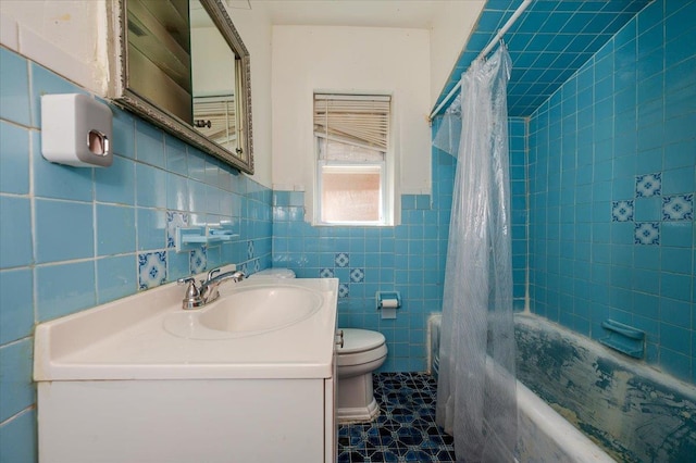 bathroom with tile walls, vanity, toilet, and shower / bath combination with curtain