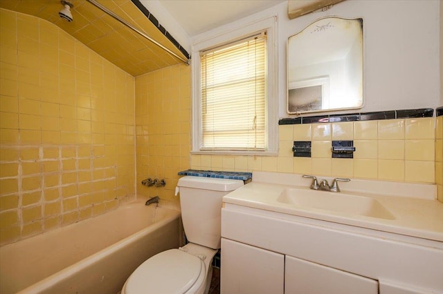 full bath with toilet, tile walls, and vanity