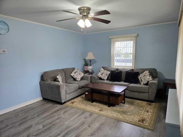 living area with crown molding, ceiling fan, and wood finished floors