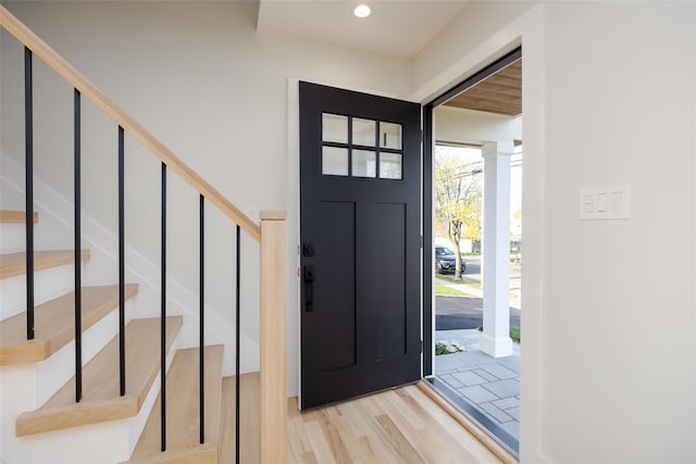 entrance foyer with wood finished floors, recessed lighting, and stairs