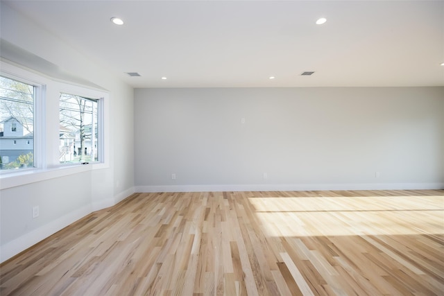 empty room with visible vents, light wood-type flooring, recessed lighting, and baseboards