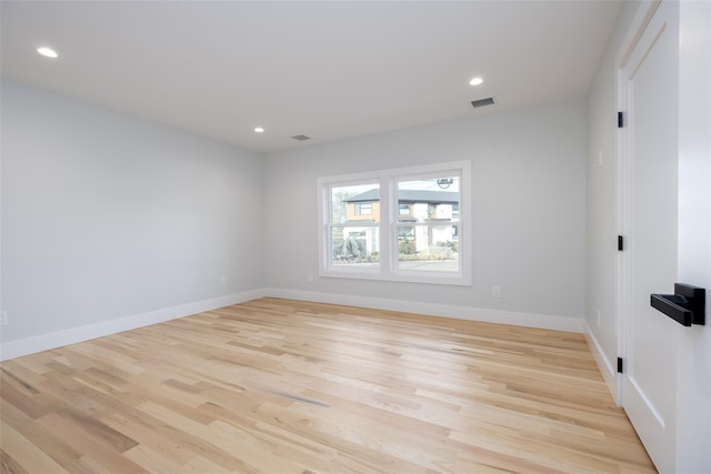 spare room featuring baseboards, visible vents, light wood-style flooring, and recessed lighting