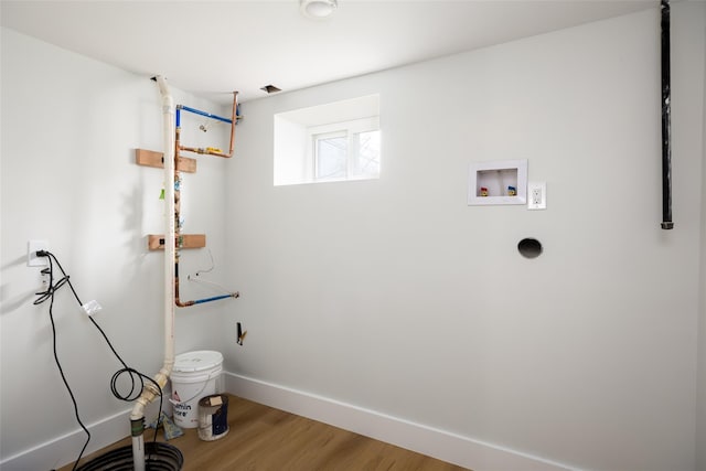 laundry area featuring hookup for a washing machine, wood finished floors, laundry area, and baseboards