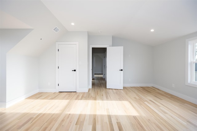 bonus room with visible vents, light wood-style flooring, vaulted ceiling, and baseboards
