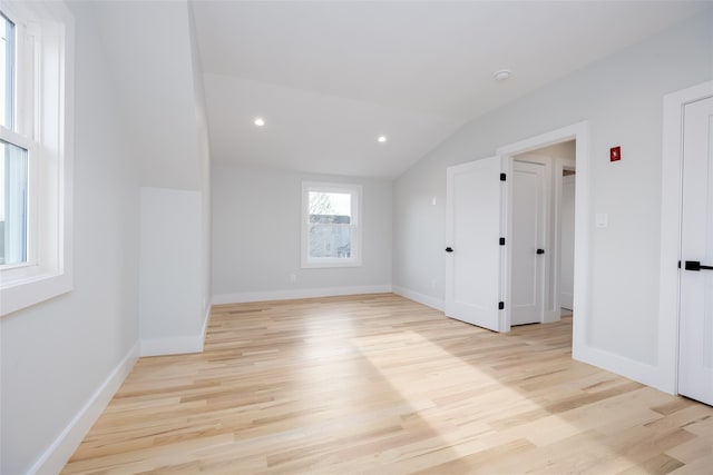 bonus room featuring light wood finished floors, vaulted ceiling, and baseboards