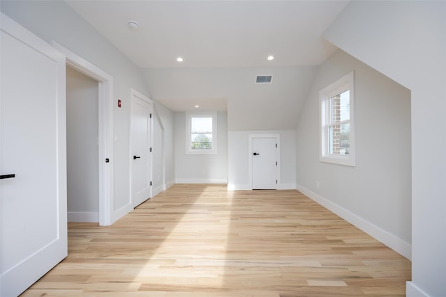additional living space with recessed lighting, visible vents, baseboards, and light wood-type flooring