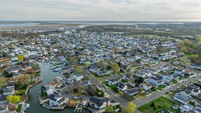 drone / aerial view with a residential view and a water view
