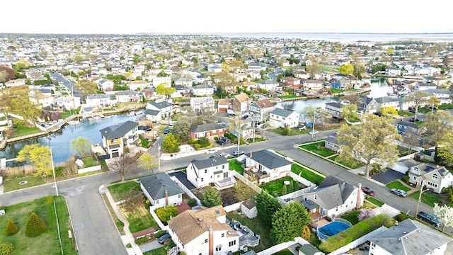 drone / aerial view with a residential view and a water view