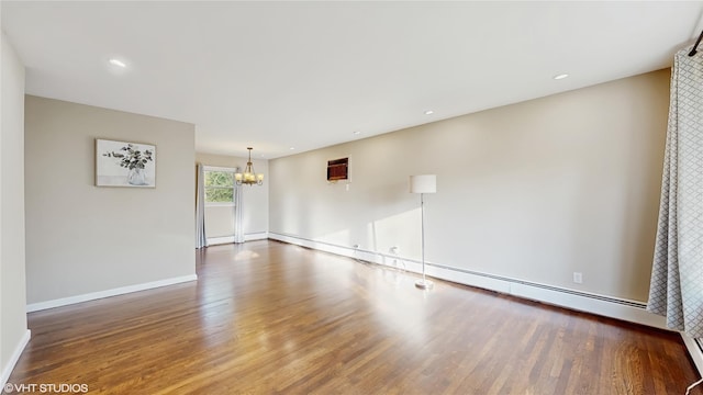 17 Fenmore Dr, Wappingers Falls, NY 12590 - spare room with baseboards, a chandelier, and wood finished floors