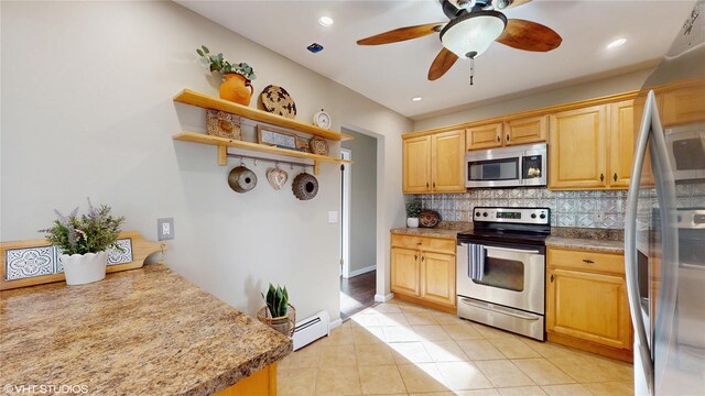 17 Fenmore Dr, Wappingers Falls, NY 12590 - kitchen with light tile patterned flooring, ceiling fan, baseboard heating, stainless steel appliances, and tasteful backsplash
