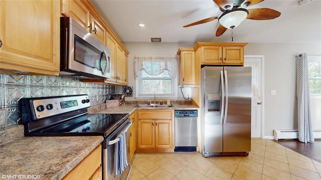 17 Fenmore Dr, Wappingers Falls, NY 12590 - kitchen featuring ceiling fan, baseboard heating, a sink, stainless steel appliances, and light tile patterned floors