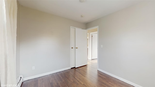 17 Fenmore Dr, Wappingers Falls, NY 12590 - empty room featuring baseboards, baseboard heating, and dark wood-type flooring