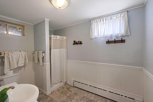 full bath with crown molding, a stall shower, a baseboard heating unit, toilet, and wainscoting