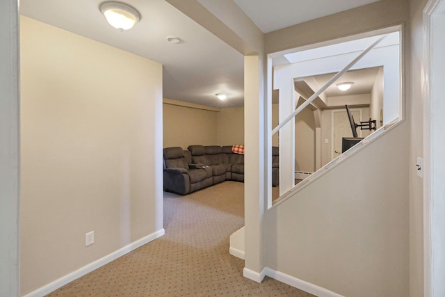 hallway with stairs, carpet floors, and baseboards