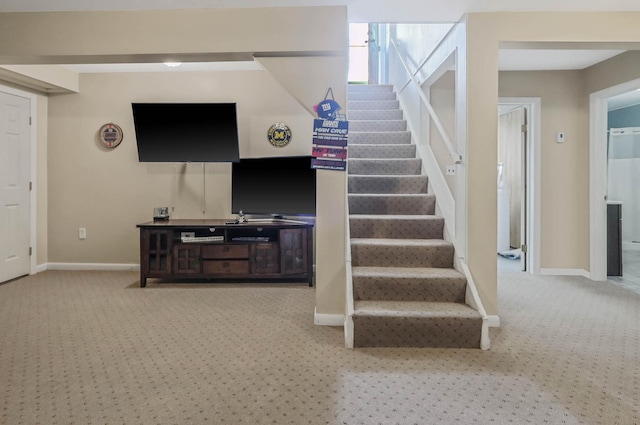 stairs featuring carpet and baseboards
