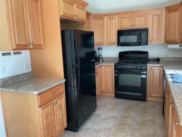 kitchen with light countertops, black appliances, and light tile patterned flooring