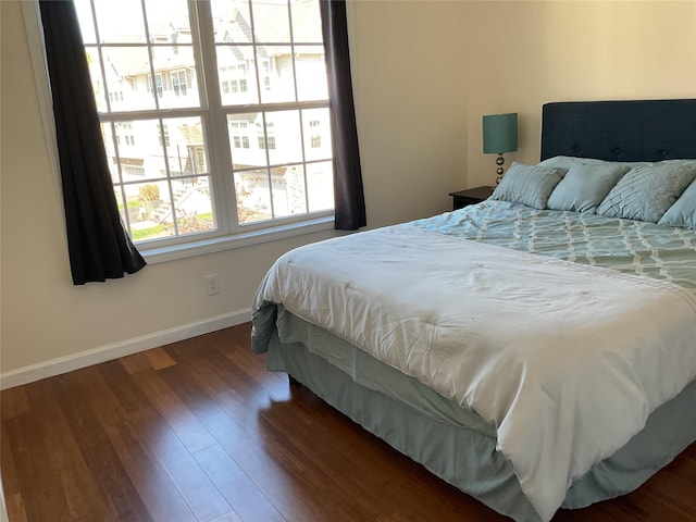 bedroom featuring baseboards and wood finished floors
