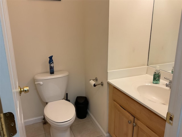bathroom with baseboards, tile patterned floors, toilet, and vanity