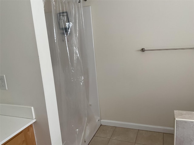 full bath featuring tile patterned floors, baseboards, and a shower with curtain