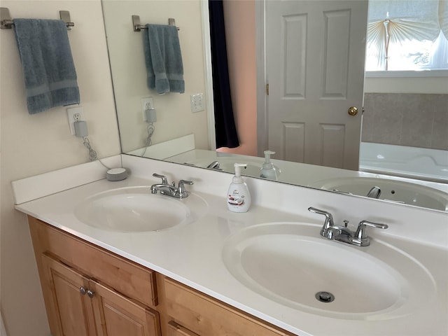 full bathroom featuring double vanity, a sink, and a tub