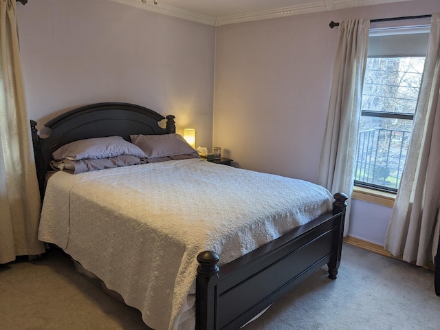 bedroom featuring ornamental molding and light colored carpet
