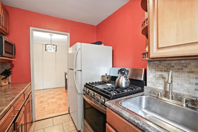 52-15 65th Pl Unit 2A, Maspeth, NY 11378 - kitchen with appliances with stainless steel finishes, a sink, decorative backsplash, and dark countertops