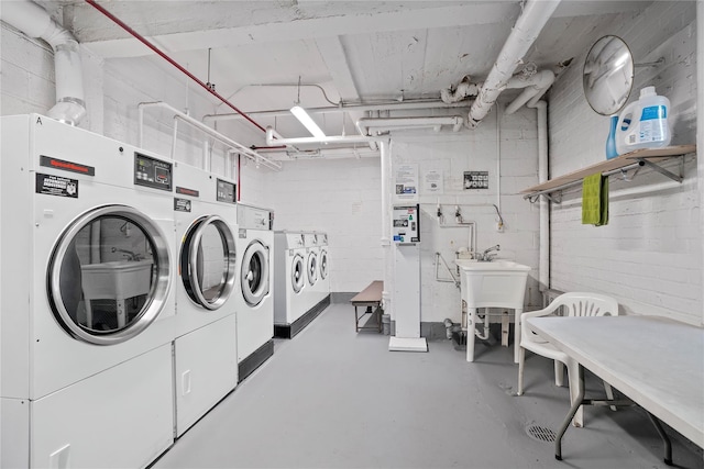 52-15 65th Pl Unit 2A, Maspeth, NY 11378 - shared laundry featuring washing machine and dryer and concrete block wall