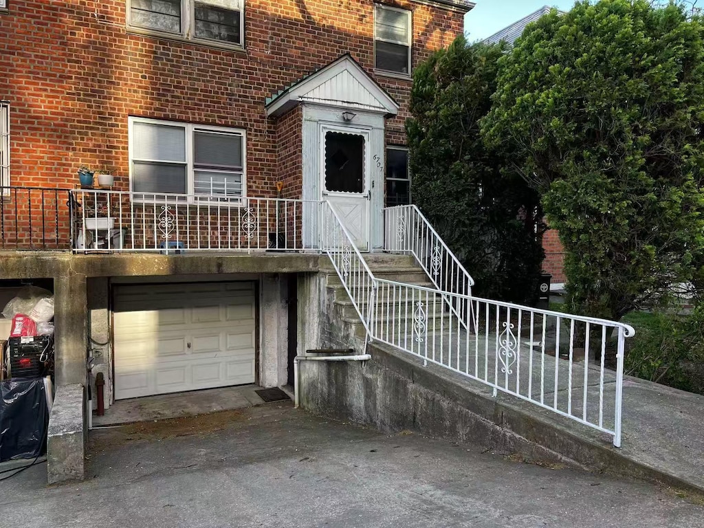 townhome / multi-family property with driveway, a garage, and brick siding
