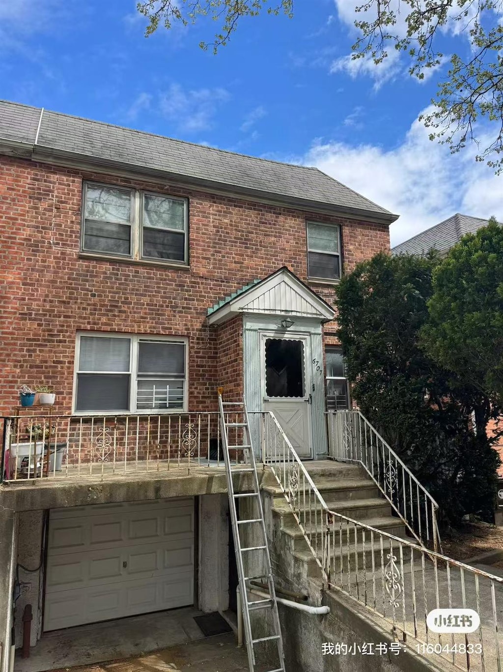 townhome / multi-family property with an attached garage, a shingled roof, and brick siding