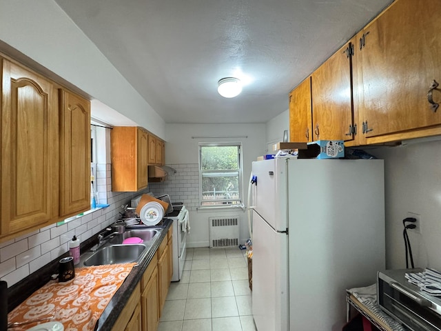 67-07 Fresh Meadow Ln, Fresh Meadows, NY 11365 - kitchen featuring brown cabinetry, radiator, white appliances, light tile patterned flooring, and decorative backsplash