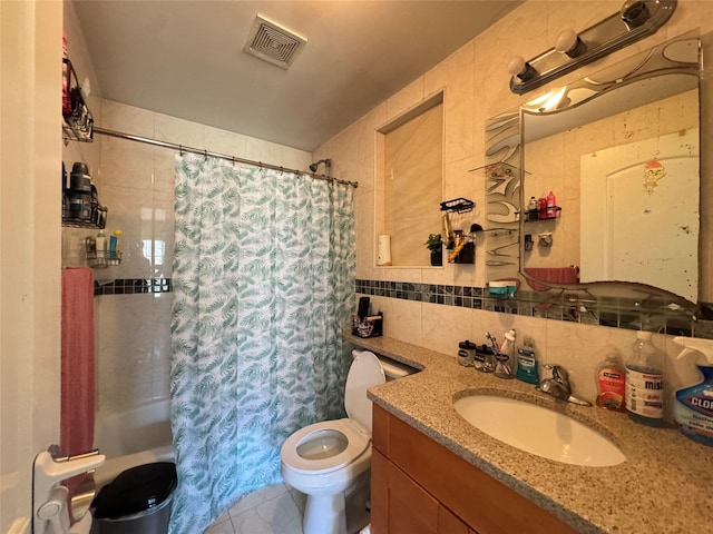 full bath featuring visible vents, shower / bath combo with shower curtain, toilet, tile walls, and vanity