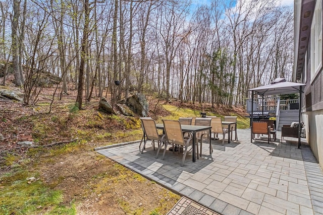 view of patio featuring outdoor dining space and a gazebo