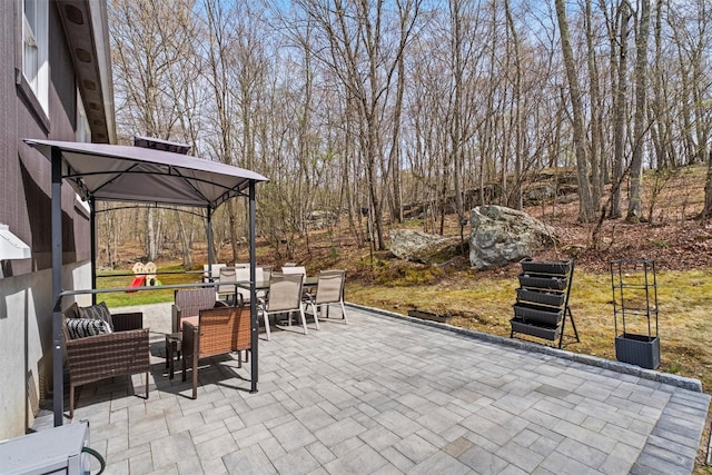 view of patio with a gazebo and outdoor dining area
