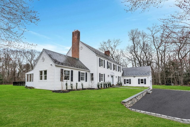 539 Split Rock Rd, Syosset, NY 11791 - rear view of house featuring a lawn, a chimney, and roof with shingles