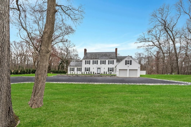 539 Split Rock Rd, Syosset, NY 11791 - view of front of home with a garage, driveway, a chimney, and a front lawn
