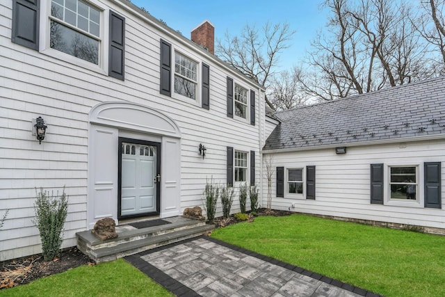 539 Split Rock Rd, Syosset, NY 11791 - property entrance with a chimney and a yard
