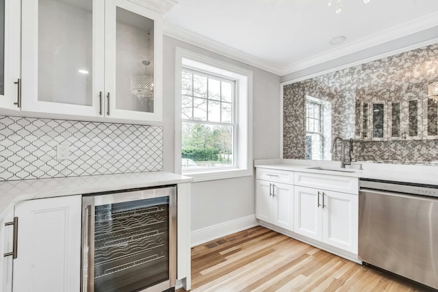 539 Split Rock Rd, Syosset, NY 11791 - bar featuring decorative backsplash, crown molding, stainless steel dishwasher, a sink, and beverage cooler