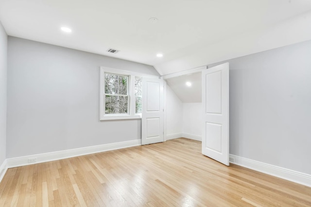 539 Split Rock Rd, Syosset, NY 11791 - additional living space with baseboards, visible vents, light wood-style flooring, and vaulted ceiling
