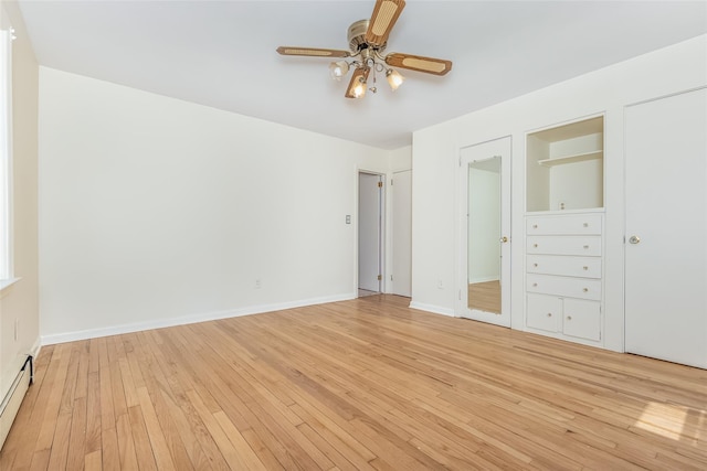 unfurnished bedroom with light wood-style floors, baseboards, ceiling fan, and a baseboard heating unit