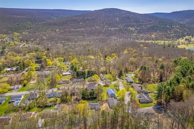 drone / aerial view with a mountain view, a residential view, and a forest view