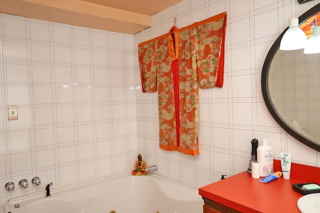bathroom with a jetted tub and vanity