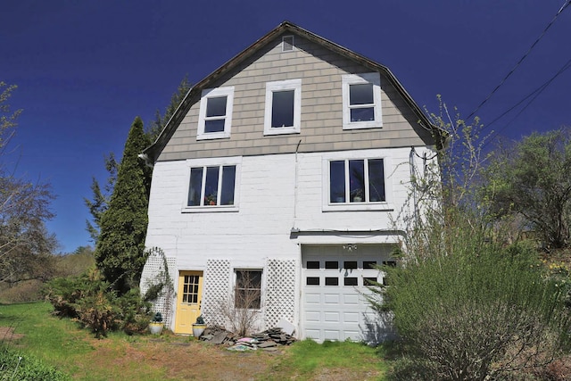 back of house featuring an attached garage