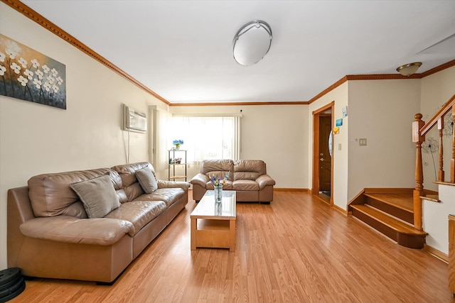 living area with baseboards, stairway, ornamental molding, and light wood finished floors